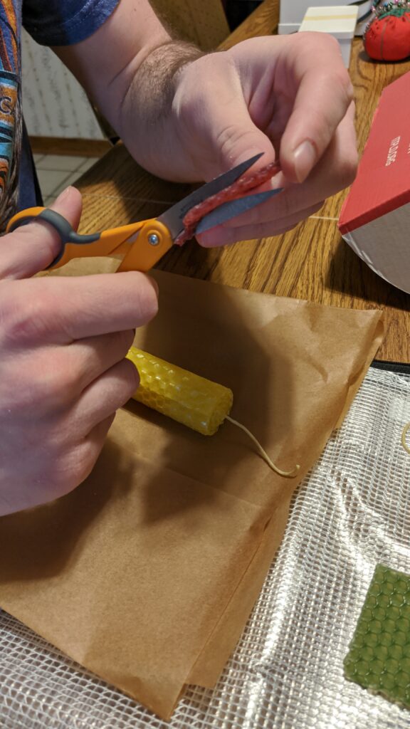 Cutting wax chips to use for decorating the candles.